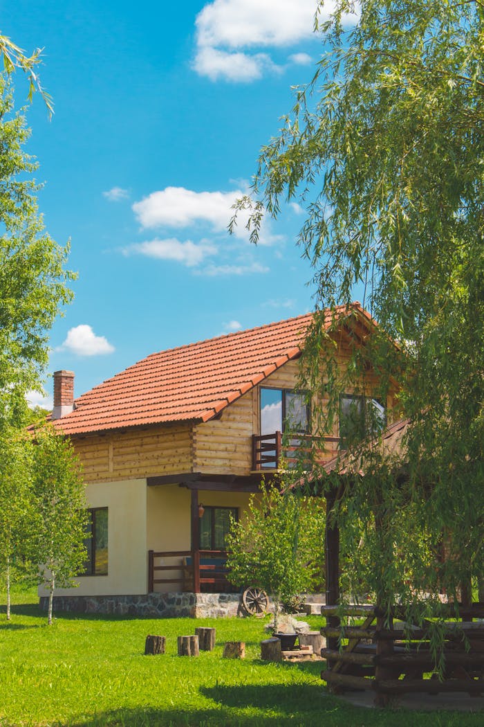 Discover a picturesque rustic house surrounded by vibrant greenery in a serene summer landscape.